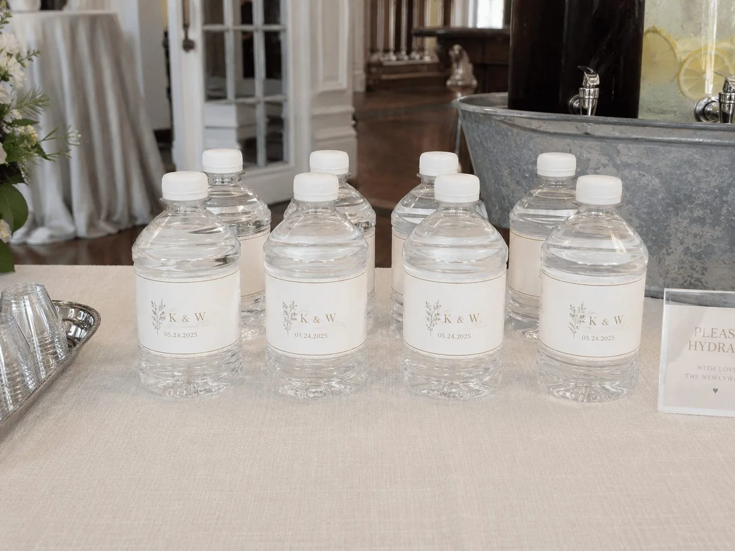 K & W monogrammed wedding bottles on the reception table