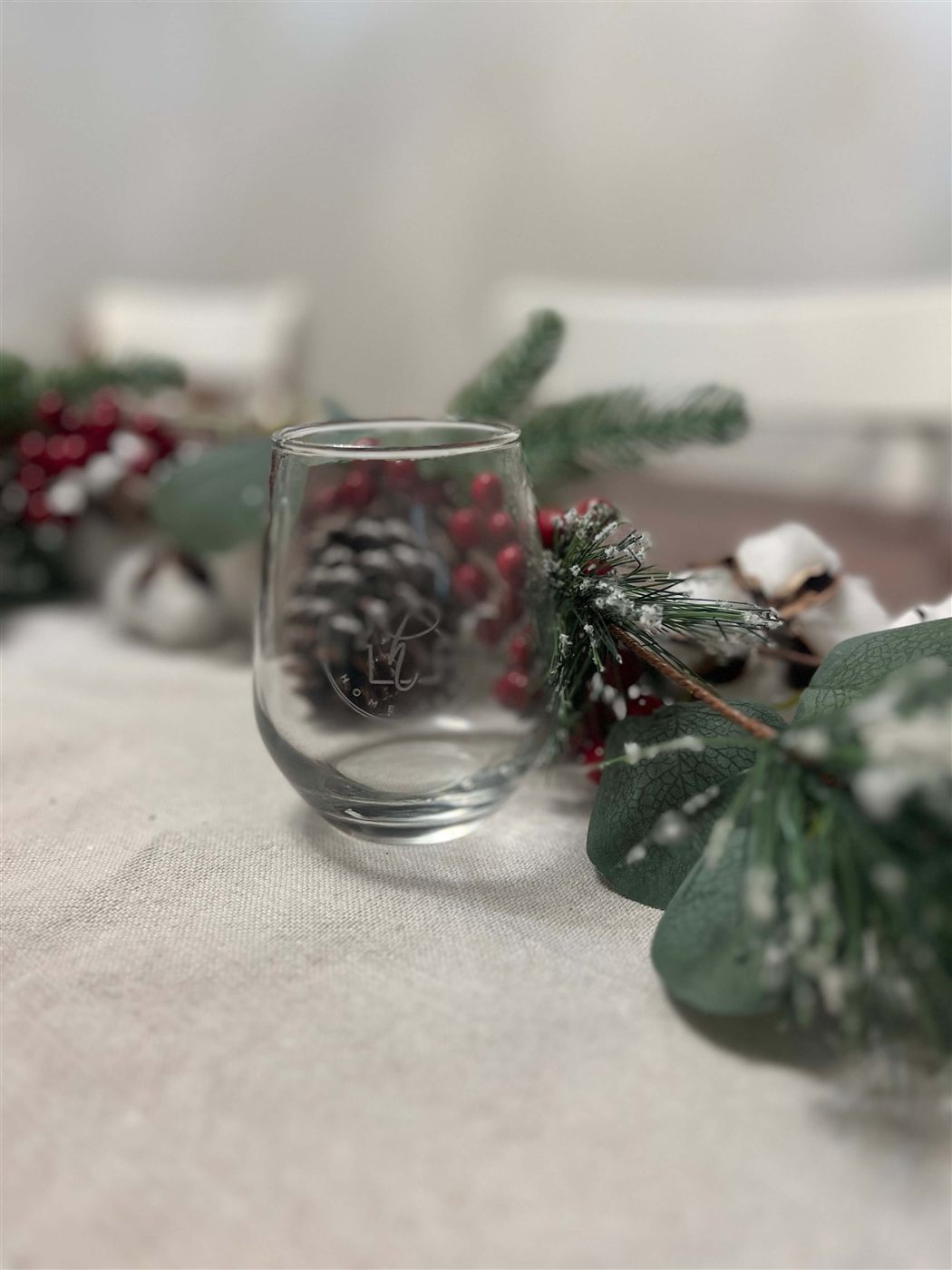 Laser-engraved stemless wine glass with a company logo
